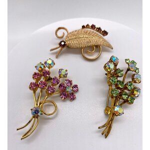 Trio of MCM brooches in gold tone with various coloured rhinestones